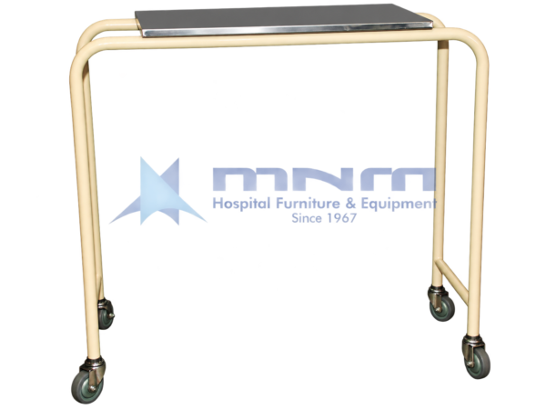 Hospital overbed table with a stainless steel top on a cream powder-coated tubular steel frame, open on one side, on four swivel castors