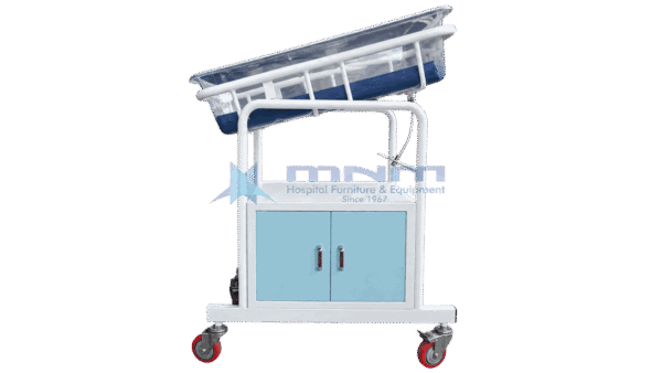 Baby cot with clear acrylic crib tilted on a white frame above a two door cabinet with light blue doors and four castors