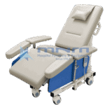 Electric dialysis recliner chair in cream upholstery with reclined backrest, head pillow, elevated legrest, wide padded arm supports both sides, corded hand control and castors with brakes