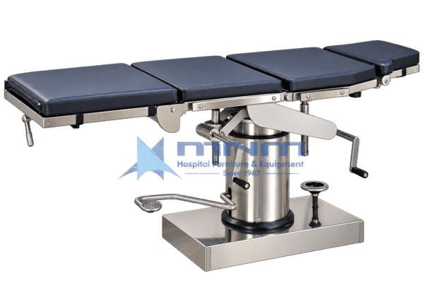 Manual operating table with navy four section upholstered top on a stainless steel frame, cylindrical hydraulic column with foot pump pedal, crank handles and rectangular stainless base