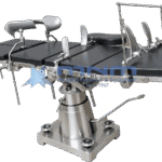 Operating table with dark upholstered top, arm supports, shoulder braces and anaesthetic screen, on a conical stainless column with four levelling pads