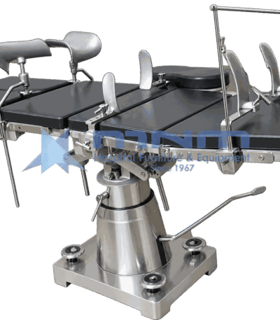 Operating table with dark upholstered top, arm supports, shoulder braces and anaesthetic screen, on a conical stainless column with four levelling pads
