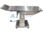 Side view of a stainless steel ophthalmology operation table showing the contoured top profile and the hinged head section folded up