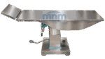 Stainless steel ophthalmology operation table with contoured one-piece top and hinged head section raised, on a pedestal column with foot pedal and handwheel