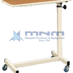 Hospital overbed table with wood-effect laminate top, moulded edge trim, cream powder-coated column with knob height lock and an H-shaped base on four castors