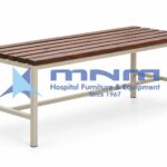 Hospital attendant bench with a wooden slat seat on a cream powder-coated steel frame