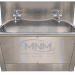 Stainless steel two station scrub sink with a single long trough, two chrome cross-handle taps on the backsplash and a panelled apron