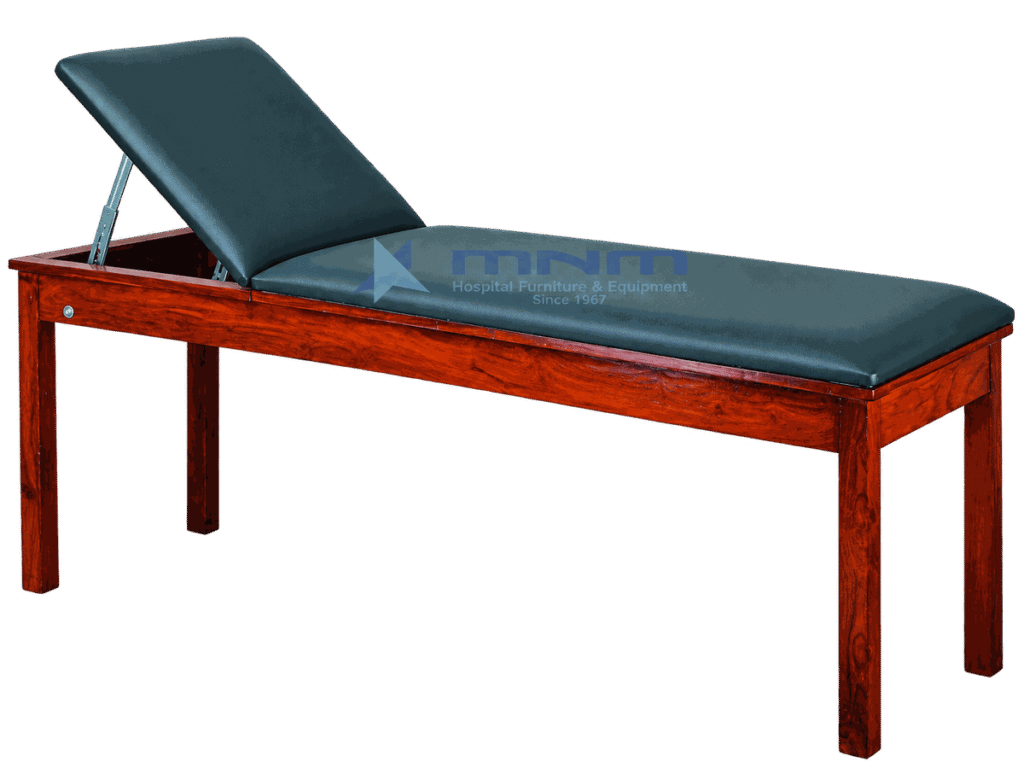 Examination couch with polished hardwood frame, dark green upholstery and backrest raised on a metal strut